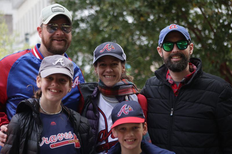 Braves fans Marcus Jordan (top left), Wilson Wilcoxon (bottom front), Chloe Wilcoxon (middle left), Ryan Wilcoxon (middle with scarf) and Bud Wilcoxon (right) attended the Braves' World Series parade in Atlanta on Nov. 5, 2021. (Photo by Anfernee Patterson/AJC)