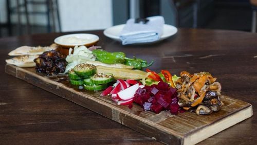 Saltyard’s Veggie Board is an assembly of seasonal raw, pickled and roasted vegetables that will change with the seasons just like the accompanying hummus — currently, field peas are the replacement for traditional chickpeas — and house-made seed crackers. CONTRIBUTED BY SALTYARD