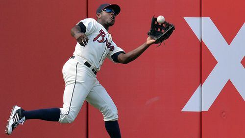 Braves left fielder Justin Upton (8) catches a fly ball hit by San Francisco Giants third baseman Joaquin Arias (13) in the 3rd inning at Turner Field in Atlanta on Saturday, June 15, 2013.