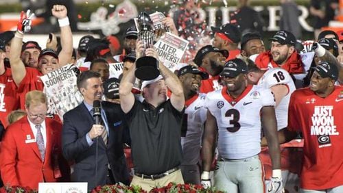 Georgia head coach Kirby Smart lifts the Rose Bowl trophy in triumph after Monday's historic win.
