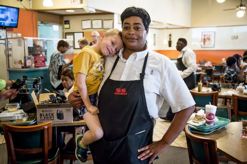 Employee Jada Pass says goodbye to Caden Brady Doyle, 5, right before the doors of the S&S Cafeteria closed for good Sunday in Atlanta. Caden has been eating at the cafeteria since he was 2 years old and knows many of the employees. STEVE SCHAEFER / SPECIAL TO THE AJC