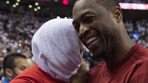 Miami Heat's Dwyane Wade, right, congratulates Toronto Raptors' Kyle Lowry following Game 7 of the NBA basketball Eastern Conference semifinals in Toronto, Sunday, May 15, 2016. The Raptors won 116-89. (Frank Gunn/The Canadian Press via AP) MANDATORY CREDIT