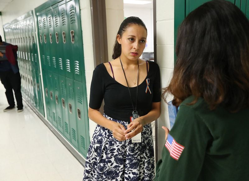 Yehimi Cambron, a metro Atlanta teacher, confers with a Cross Keys High School student. Both fall under the Obama-era Deferred Action for Childhood Arrivals program, which provides documentation for residents brought to the country as children. Cambron was in Washington this week, lobbying for action and a path to permanent resident status for the country’s undocumented population.Curtis Compton/ccompton@ajc.com