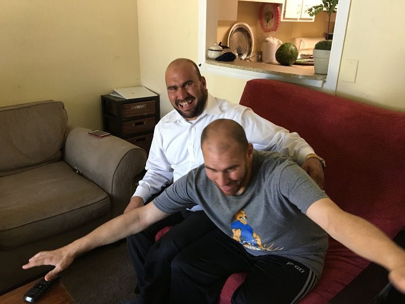 Jehad Al Homsi, 43, enjoys a light moment recently with one of his twin brothers. Homsi resettled in Clarkston last year after fleeing his native Syria with his wife, three children and twin brothers Fayez and Nayel, who are mentally disabled. CONTRIBUTED