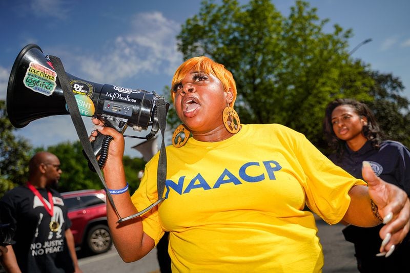 Porchse Miller with the NAACP leads protesters in chants in the village of Stone Mountain before a rally at the park. (Photo: Ben Hendren for The Atlanta Journal Constitution)