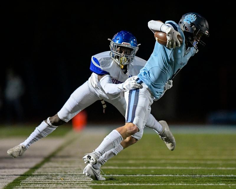 Riverwood cornerback Khalil Anderson (2) forces Cambridge wide receiver Hayden Gardella (4) out of bounds during a play in the first half Friday, Nov. 6, 2020, in Milton. (Daniel Varnado/For the AJC)