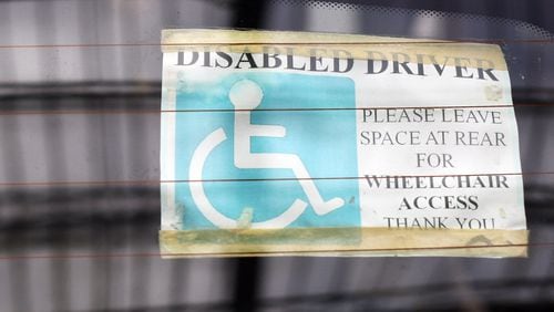BATH, ENGLAND - FEBRUARY 16:  A sticker is displayed in the window of a car parked in a disabled car parking bay in a supermarket car park on February 16, 2011 in Bath, England. The government is currently considering a range of measures after it was revealed that the system - which allows badge holders free parking in many pay-and-display bays, at meters and on single- and double-yellow lines - was being widely abused. Currently, over 2.5million people qualify for the scheme, but research has shown that over a half of users are not entitled to use them and that there is widespread fraud and abuse involving the badges.  (Photo by Matt Cardy/Getty Images)