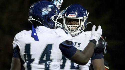 Cedar Grove defenders Malachi Madison (44) and Christen Miller (right) celebrate a defensive play against GAC in the second half Friday, Oct. 23, 2020, at Greater Atlanta Christian in Norcross, Ga.. Cedar Grove won 33-6. (Jason Getz/For the AJC)
