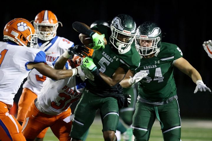 Dec. 11, 2020 - Suwanee, Ga: Collins Hill wide receiver Sean Norris (5) fights for extra yards against Parkview with help from Collins Hill offensive lineman Lucas Kulig (54) in the first half of the Class AAAAAAA quarterfinals game at Collins Hill high school Friday, December 11, 2020 in Suwanee, Ga.. JASON GETZ FOR THE ATLANTA JOURNAL-CONSTITUTION