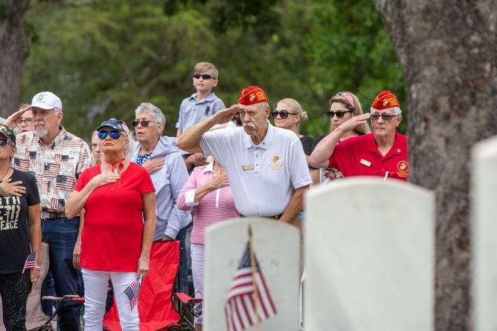 Marine veteran Doug Tasse, white shirt, second from right, salutes during the Pledge of Allegiance the 77th annual Memorial Day Observance at the Marietta National Cemetery on Monday, May 29, 2003.  (Jenni Girtman for The Atlanta Journal-Constitution)