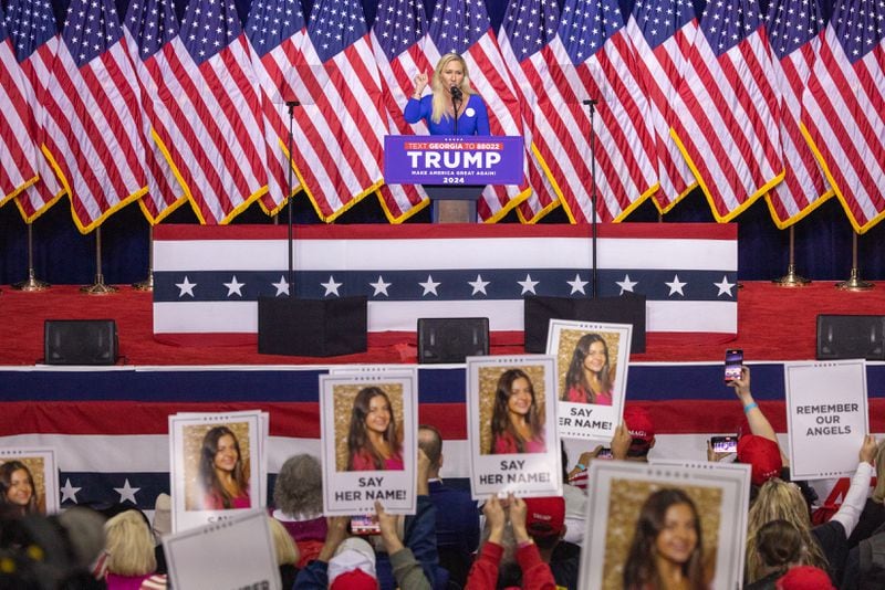 U.S. Rep. Marjorie Taylor Greene, R-14th district, speaks about slain nursing student Laken Riley as supporters hold signs with her photo at a rally for presidential candidate and former president Donald Trump in Rome on Saturday, March 9, 2024. (Arvin Temkar / arvin.temkar@ajc.com)