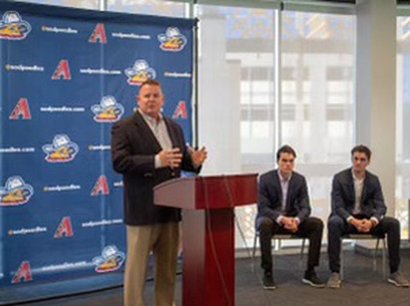 Amarillo Sod Poodles President and General Manager Tony Ensor (standing) introduces his team's new broadcasters Stefan Caray (seated on left) and Chris Caray (seated on right). (Photo by Isaac Galan / Special to the AJC)