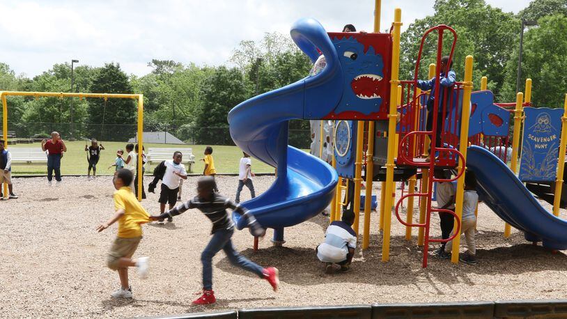 Children play on the playground at Dobbs Elementary School in Atlanta on Wednesday, May 1, 2019. Dobbs is among 11 Atlanta schools interested in a program that would open up its playground for use as a public park during the summer, on the weekends and after school. EMILY HANEY / emily.haney@ajc.com