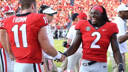 September 2, 2017 Athens: Georgia wide receiver Jayson Stanley congratulates freshman quarterback Jake Fromm on the sidelines after he comes in the game replacing injured starting quarterback Jacob Eason and leads Georgia to a touchdown for a 7-0 lead during the first quarter against Appalachian State in a NCAA college football game on Saturday, September 2, 2017, in Athens.    Curtis Compton/ccompton@ajc.com