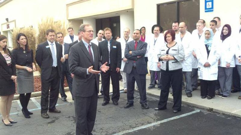 Then-U.S. Rep. Jack Kingston officiates a ribbon cutting ceremony for Confirmatrix Dec. 6, 2013, hours before attending a fundraiser for his U.S. Senate campaign orchestrated by two companies linked to Khalid Satary, a felon under a U.S. deportation order.