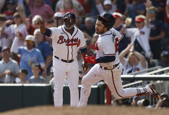 Atlanta Braves' Travis d'Arnaud doubles to score Matt Olson and William Contreras during the fifth inning of game one of the baseball playoff series between the Braves and the Phillies at Truist Park in Atlanta on Tuesday, October 11, 2022. (Jason Getz / Jason.Getz@ajc.com)
