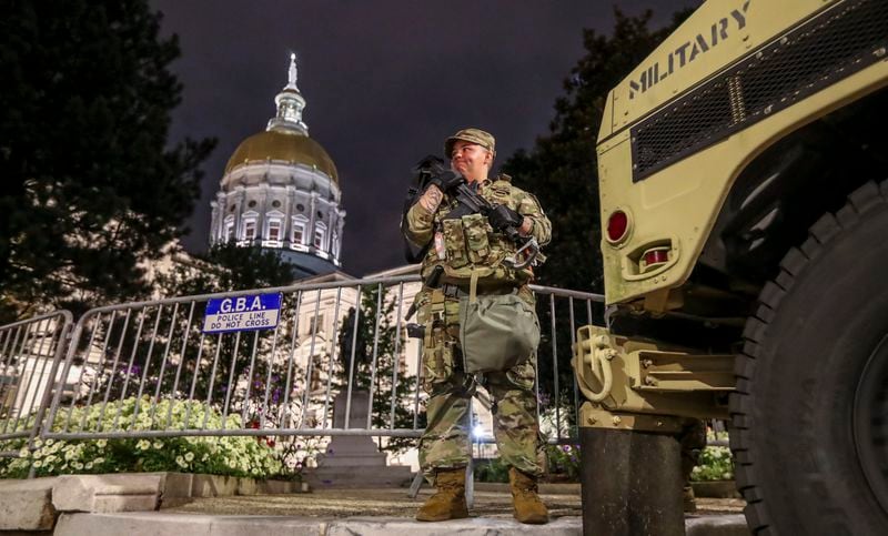 Specialist O'Donnell stands guard in front of the Georgia State Capitol building in Atlanta on July 8, 2020, after the Georgia National Guard were dispatched in response to a surge of violence in Atlanta and the ransacking of the Georgia State Patrol's headquarters. Gov. Brian Kemp issued an emergency declaration on July 6 following shootings that left five dead in Atlanta, including an 8-year-old girl. Kemp said peaceful protests had been hijacked by criminals with a dangerous, destructive agenda. (JOHN SPINK/JSPINK@AJC.COM)