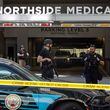 Law enforcement officers are seen on West Peachtree Street in front of Northside Hospital Midtown medical office building, where five people were shot on Wednesday, May 3, 2023. (Arvin Temkar/The Atlanta Journal-Constitution/TNS)