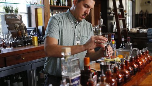 Miles Macquarrie mixes classic cocktails at the Kimball House in Decatur. / AJC file photo