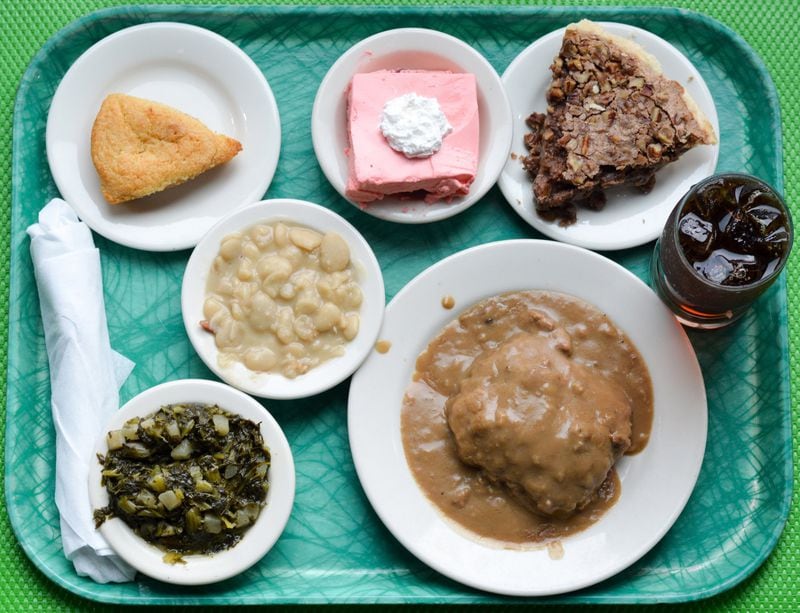 A full tray from Magnolia Room Cafeteria includes country-fried steak, lima beans, turnip greens, cracklin cornbread, strawberry congealed salad and German chocolate pie for less than $12. CONTRIBUTED BY HENRI HOLLIS
