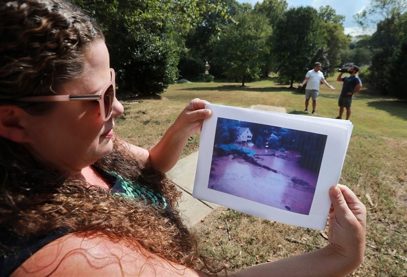 September 26, 2019 Atlanta: Local resident Lillian Miller holds a 2009 photo of flooding on the site in Peoplestown where it happened. Four residents remain hopeful their legal fight with the city to keep their home will end soon, while other longtime Peoplestown residents say they’ve been plagued by flooding and that the pending litigation has kept the city from progressing on a retention pond that would prevent further flooding. Curtis Compton/ccompton@ajc.com