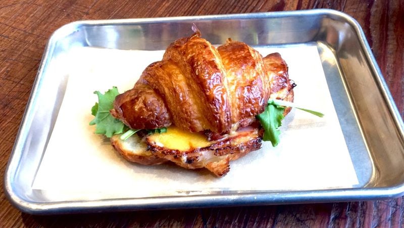 Root Baking Co. serves marvelous croissants for breakfast; this one is stuffed with sorghum-glazed ham and cheddar. CONTRIBUTED BY WENDELL BROCK