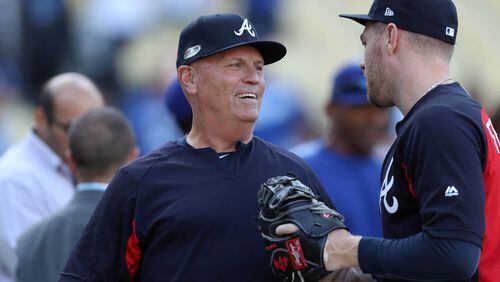 Braves manager Brian Snitker talks with first baseman Freddie Freeman as they prepare for Game 2 against the Los Angeles Dodgers of a National League Division Series baseball game Friday, October 5, 2018, in Los Angeles. (JASON GETZ/SPECIAL TO THE AJC)