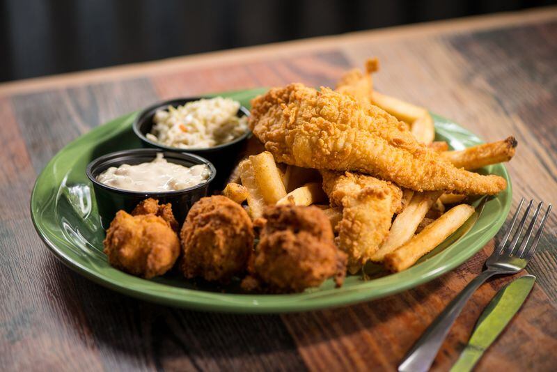  Catfish and Chips with two fried fillets with spicy tartar, hush puppies, jalapeno slaw, and fries. Photo credit- Mia Yakel.