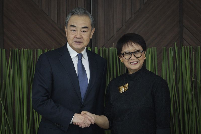 Indonesian Foreign Minister Retno Marsudi, right, shakes hands with Chinese Foreign Minister Wang Yi during their bilateral meeting in Jakarta, Indonesia, Thursday, April 18, 2024. (Yasuyoshi Chiba/Pool Photo via AP)