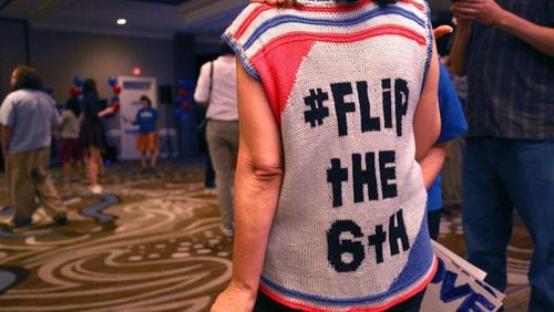 A supporter of Jon Ossoff wears a sweater she made with the "Flip the Sixth" slogan to his election-night watch party, June 20. (AJC Photo / Jason Getz)