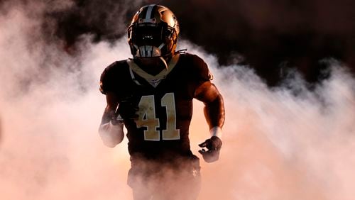 New Orleans Saints running back Alvin Kamara (41) runs on the field for player introductions during pre-game ceremonies before an NFL football game against the Carolina Panthers in New Orleans, Sunday, Dec. 3, 2017. (AP Photo/Gerald Herbert)
