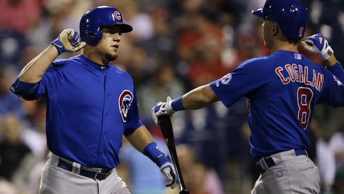 Chicago Cubs' Kyle Schwarber, left, and Chris Coghlan celebrate after Schwarber hit a home run off Philadelphia Phillies starting pitcher Jerad Eickhoff during the third inning of a baseball game, Saturday, Sept. 12, 2015, in Philadelphia. (AP Photo/Matt Slocum)