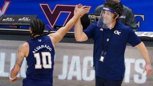 Georgia Tech guard Jose Alvarado (10) gives a high-five to head coach Josh Pastner after their 80-75 win over Florida State in the ACC championship game Saturday, March, 13, 2021, in Greensboro, N.C. (Gerry Broome/AP)