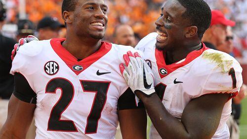 Georgia tailbacks Nick Chubb (left) and Sony Michel celebrate one of the many good moments from their senior season. (Curtis Compton/ccompton@ajc.com)