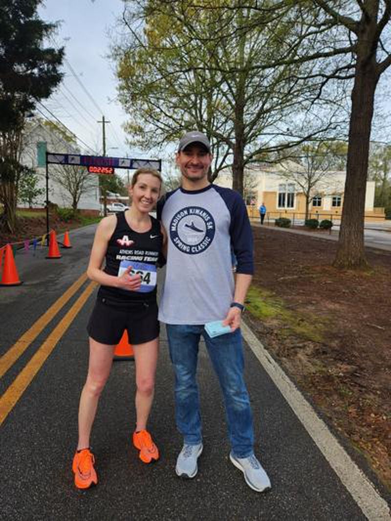 Race Committee chair Tom Greenfield congratulates the female winner and second place overall, Krystina Stoner. (Photo Courtesy of Brad Rice)