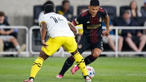 Atlanta United's Ronald Hernandez, right, tries to dribble past Columbus Crew's Waylon Francis during the second half of an MLS soccer match Saturday, Aug. 7, 2021, in Columbus, Ohio. (AP Photo/Jay LaPrete)