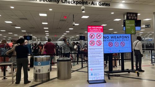 Travelers stood in line at the main security checkpoint at Hartsfield-Jackson International Airport on Thursday, March 31, 2022, just before the busy spring break travel period begins.