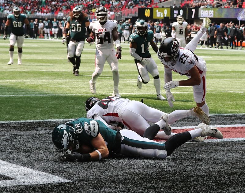 Philadelphia Eagles tight end Dallas Goedert scores a touchdown - past Falcons defenders Deion Jones and Erik Harris (23) - that held up after review with 2 seconds left in the second quarter Sunday, Sept. 12, 2021, at Mercedes-Benz Stadium in Atlanta. (Curtis Compton / Curtis.Compton@ajc.com)