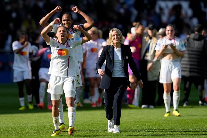 Lyon's Selma Bacha, Wendie Renard and coach Sonia Bompastor, from left, celebrate at the end of the women's Champions League semifinal, second leg, soccer match between Paris Saint-Germain and Olympique Lyonnais at Parc des Princes, in Paris, Sunday, April 28, 2024. Lyon won 2-1 to advance to the final. (AP Photo/Thibault Camus)