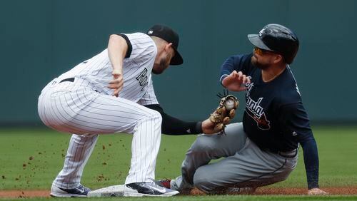 Colorado Rockies shortstop Trevor Story, left, applies a late tag on Atlanta Braves’ Ender Inciarte as Inciarte steals second base in the first inning of a baseball game Thursday, Aug. 17, 2017, in Denver. (AP Photo/David Zalubowski)