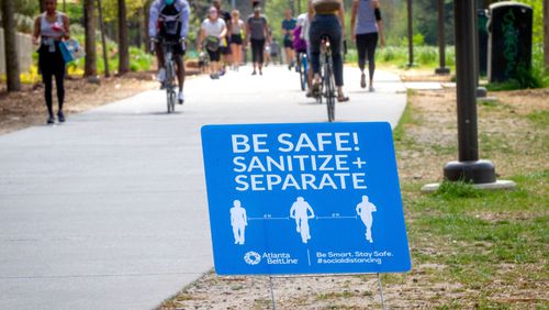Signs are posted along the Beltline, urging people to stay separated in Atlanta, March 28, 2020. STEVE SCHAEFER / SPECIAL TO THE AJC