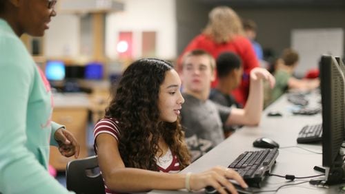 Students log in at the Flex lab to check on their coursework at Locust Grove Middle School in Henry County. BOB ANDRES / BANDRES@AJC.COM