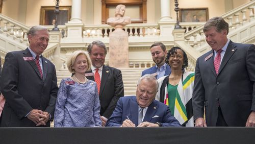 Gov. Nathan Deal signs the 2019 fiscal year state budget at the Georgia state Capitol. Deal has made it a priority while governor to build up the state’s reserves, which are now estimated at $2.5 billion, to guard against an economic downturn. ALYSSA POINTER/ALYSSA.POINTER@AJC.COM