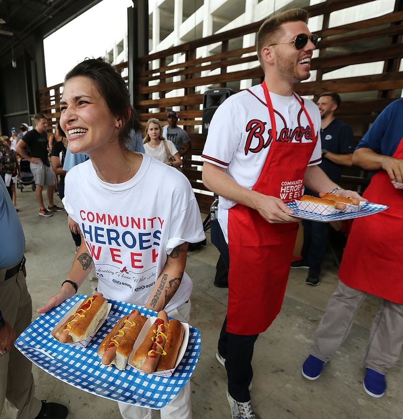 Jen Hidinger of Staplehouse and The Giving Kitchen teams up with Atlanta Braves first baseman Freddie Freeman to hand out free hot dogs at the Ponce City Market on June 19, 2017, in Atlanta. The Braves honored Hidinger with a Community Hero Award. 
