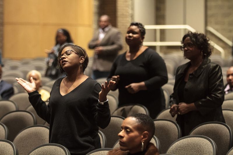 Members of the congregation of Transforming Faith Church pray during the Sunday service At Southwest DeKalb High School on Oct. 29, 2017. STEVE SCHAEFER / SPECIAL TO THE AJC