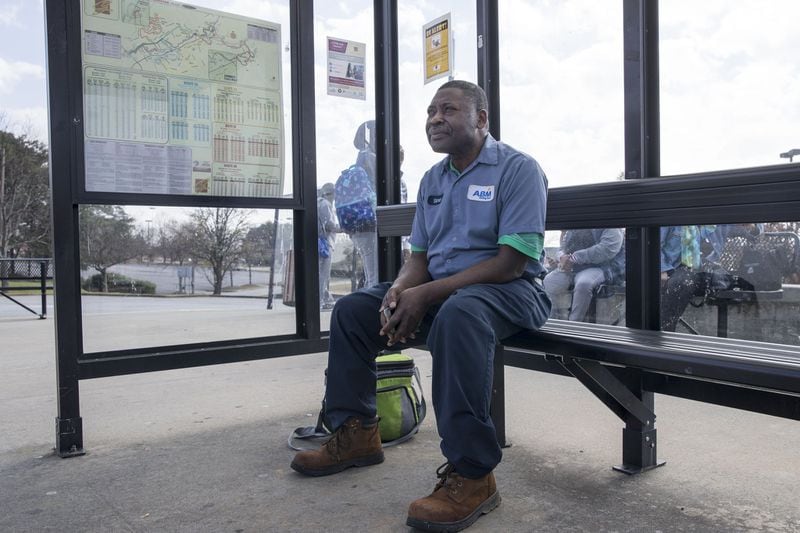 Simon Tshimanga of Duluth waits for a Gwinnett County transit bus at the Gwinnett Transit Center in Duluth Friday. Simon, a second shift custodian with ABM, uses the transit system to get to work. Siurveys show a majority of Gwinnett County residents would pay more taxes to expand mass transit. ALYSSA POINTER/ALYSSA.POINTER@AJC.COM