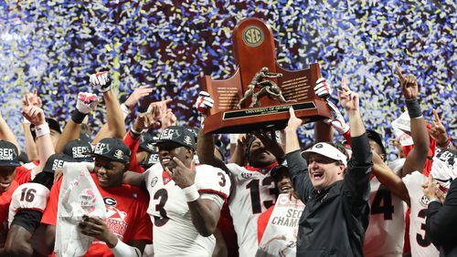 Georgia Bulldogs celebrate their SEC championship after defeating Auburn s 28-7  at Mercedes-Benz Stadium on Saturday.