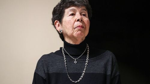 Wearing a Star of David pendant around her neck, Manuela (last name) stands as she is acknowledged during a ceremony for International Holocaust Remembrance Day at the Georgia State Capitol in Atlanta, Monday, January 27, 2020.