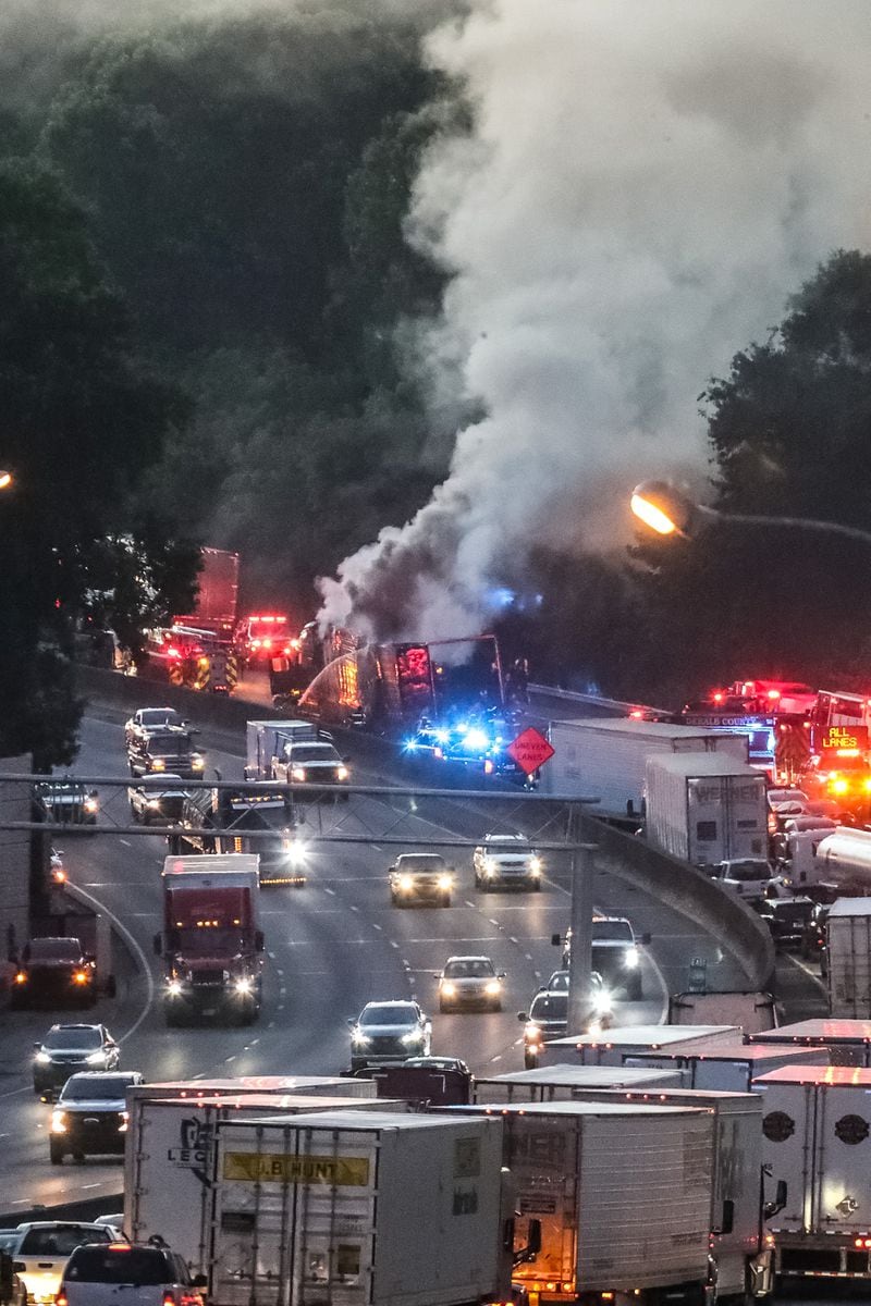 Huge plumes of smoke could be seen billowing from the charred tractor-trailer as fire crews remained on the scene.