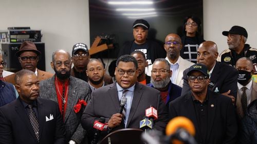 Surrounded by members of the community, Rev. Shanan Jones, President of the Concerned Black Clergy speaks to the media about gun violence in Atlanta during a forum at Vicars Community Center on Monday, December 5, 2022. (Natrice Miller/natrice.miller@ajc.com)  
